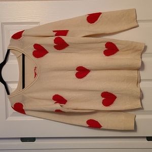 Cream sweater with red hearts.